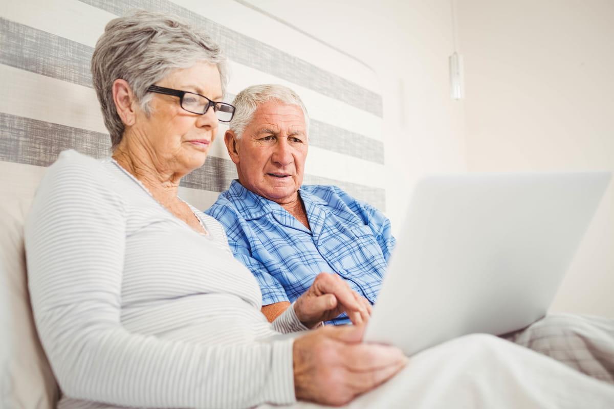 Senior couple seeking information on laptop computer