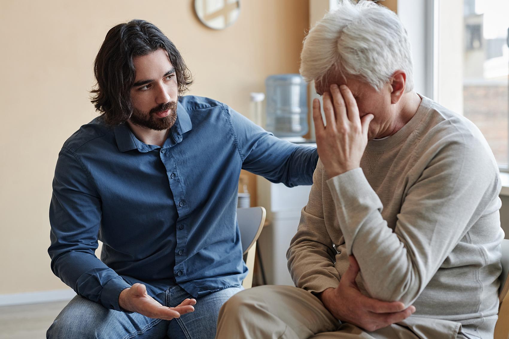 Man supporting older adult with depression