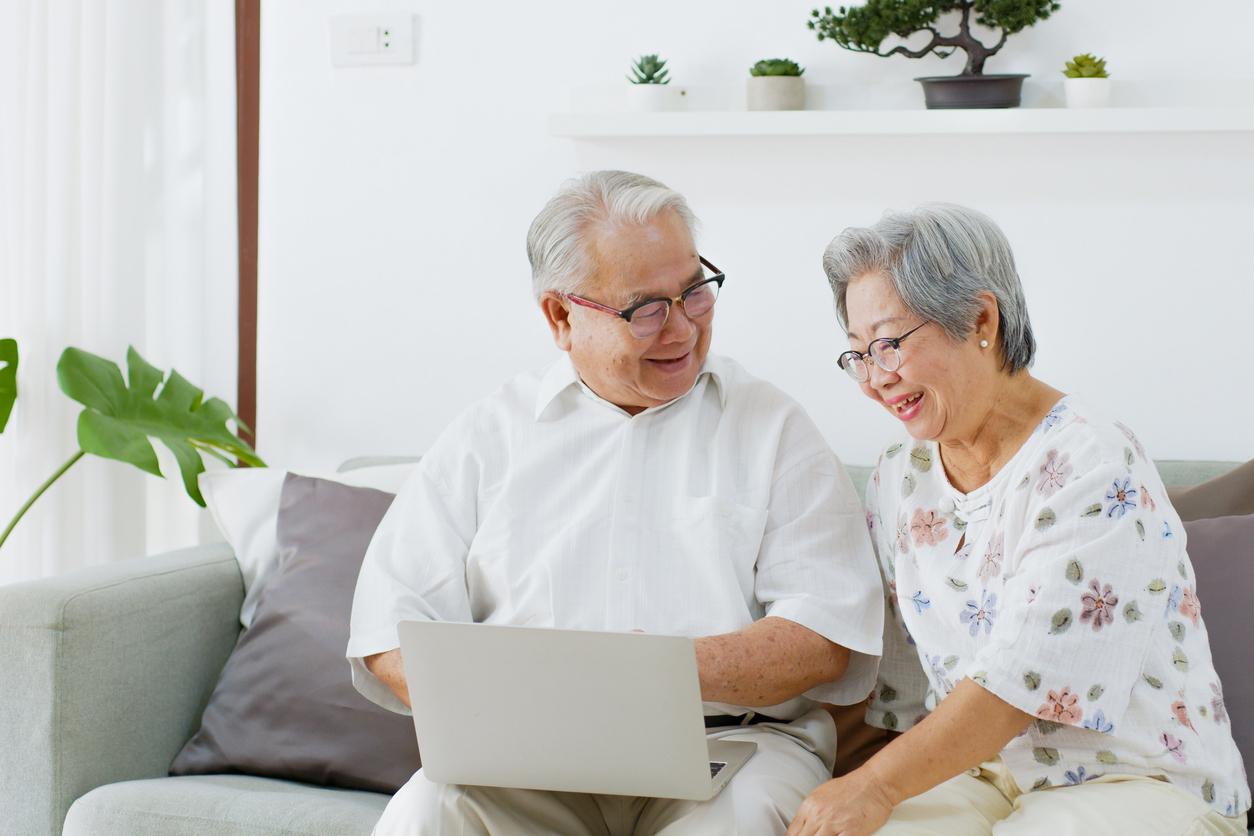 Senior man helps wife to make a GP appointment